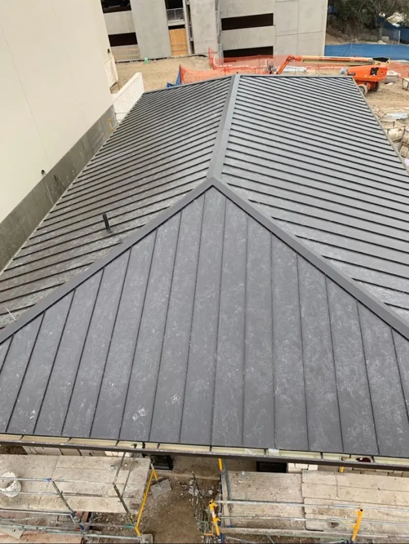Commercial metal roof construction with crane equipment in Ephrata